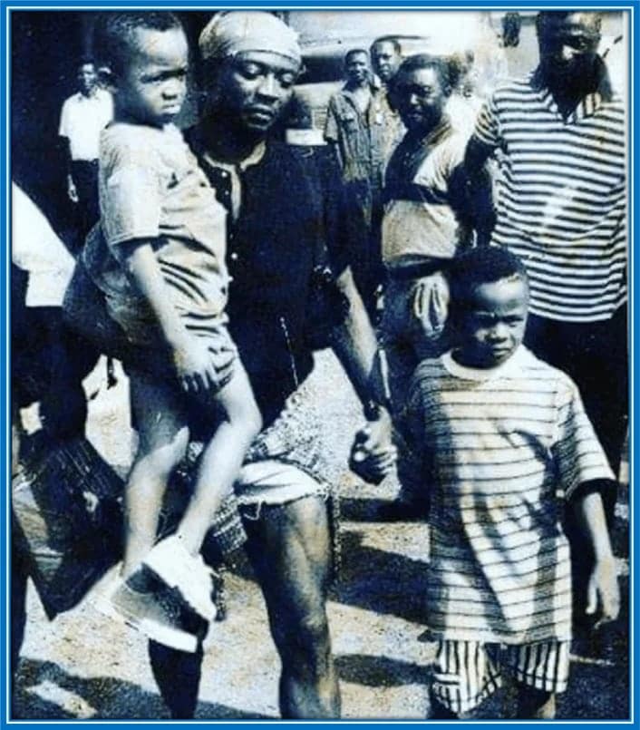 As he walks down Ghana's street, Abedi Pele carried his youngest son, Jordan, while he holds little Andre. A crowd of fascinated onlookers were so happy to see their country's football hero with his beloved sons.