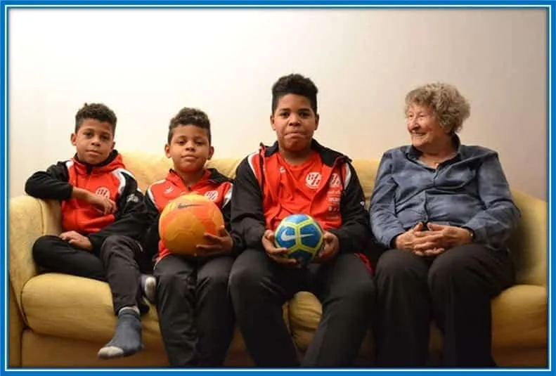 Aaron, Gideon and Desmond (from left to right) are pictured in their family home with their grandmother.