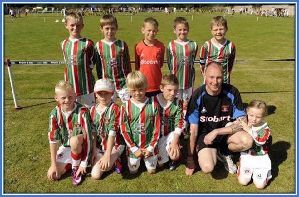 At the front left is Jarrad. His best friend Liam Lightfoot is at the back left. The boys took a photo with Carlisle United Under-9s. The boys just were about to participate in a Harraby Catholic Football tournament at Gillford Park.