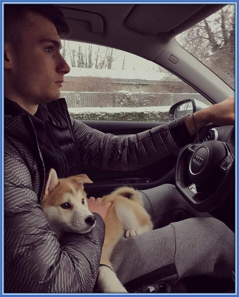 A 2018 photo of the Dinamo Zagreb Goalkeeper driving with his Dog.