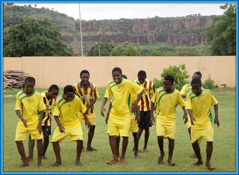 The Malian football (smiling profusely) appears to be a leader in his youth team.