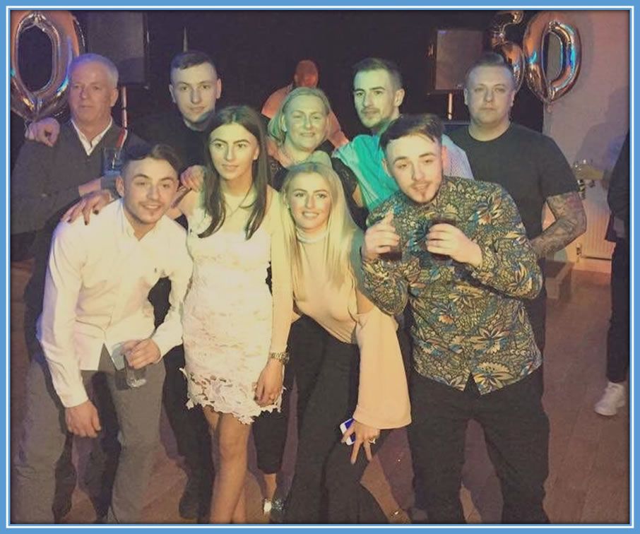 The Kelly family, all nine members, gather together for a cherished moment, with the girls and two of the triplet brothers forming the forefront, and the rest of the family standing behind, symbolizing the strength and closeness that binds them. Source: Instagram/Chloekelly