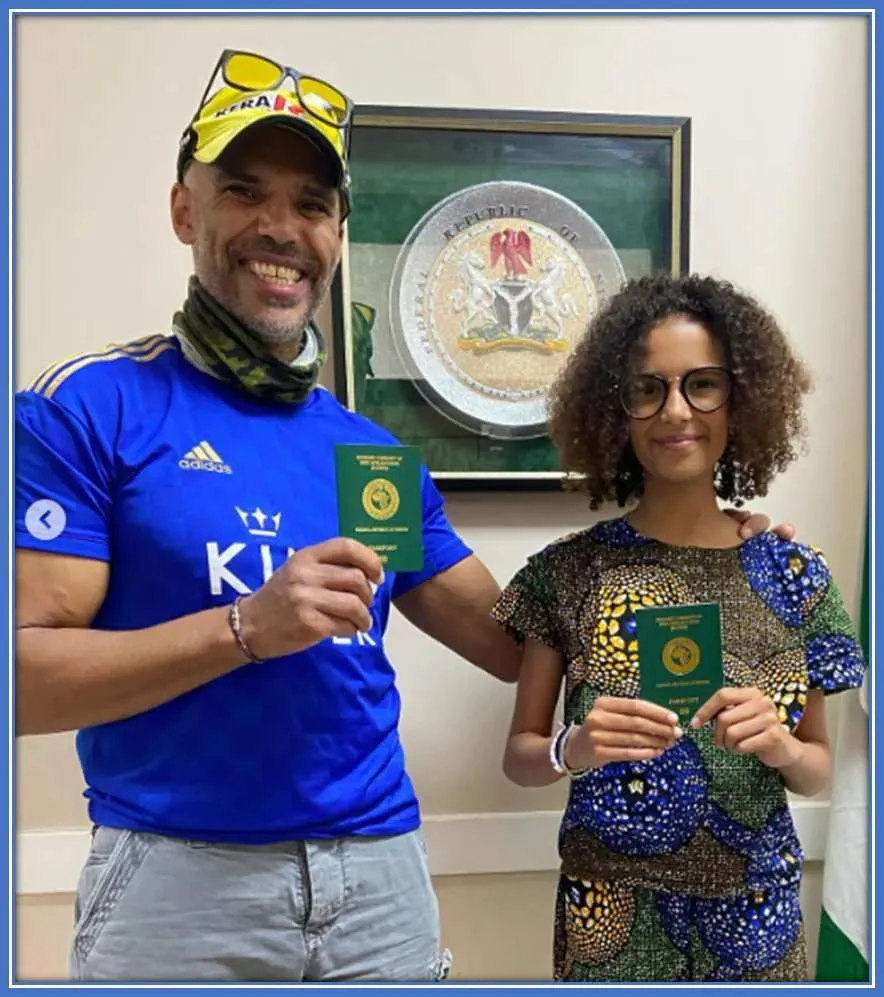 A pix of Ashleigh Plumptre's dad, Tim with her younger sister, Bisi flaunting their Nigerian passport.