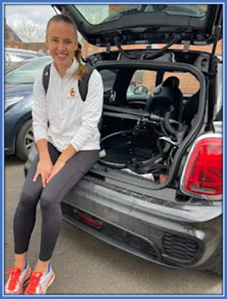 Ashleigh Plumptre - siting at the behind of one of her cars.