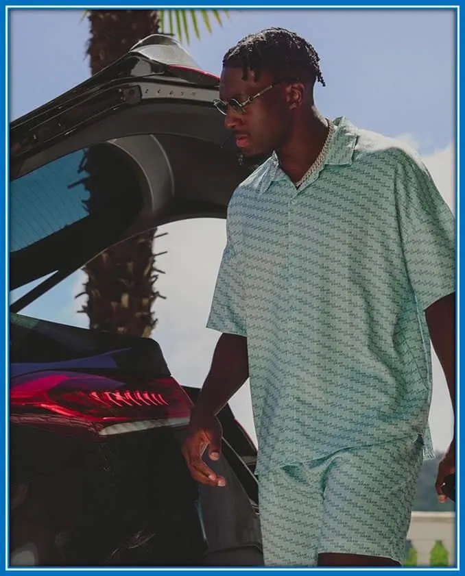 The Chelsea Defender, with his luxury car, as he loads his luggage, harking back to his vehicle-owning Monaco days.