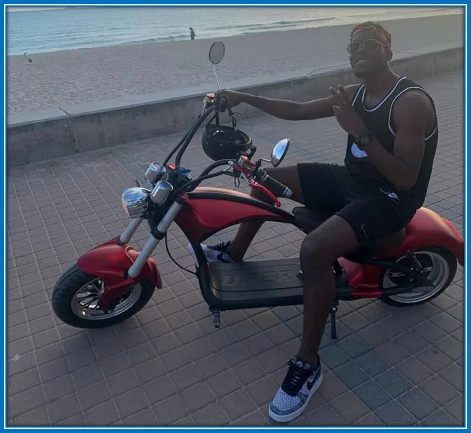 Axel Disasi, enjoying his passion for red bikes, as he rides around during his leisure.