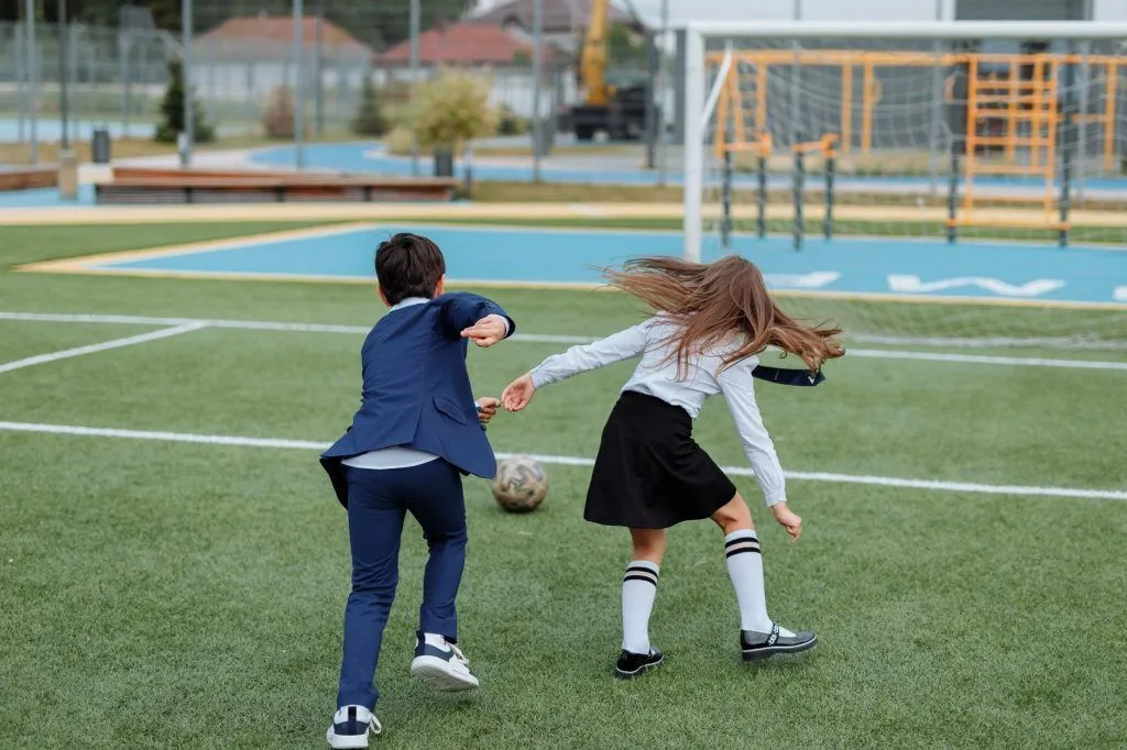 Illustrative stock photo: siblings playing soccer