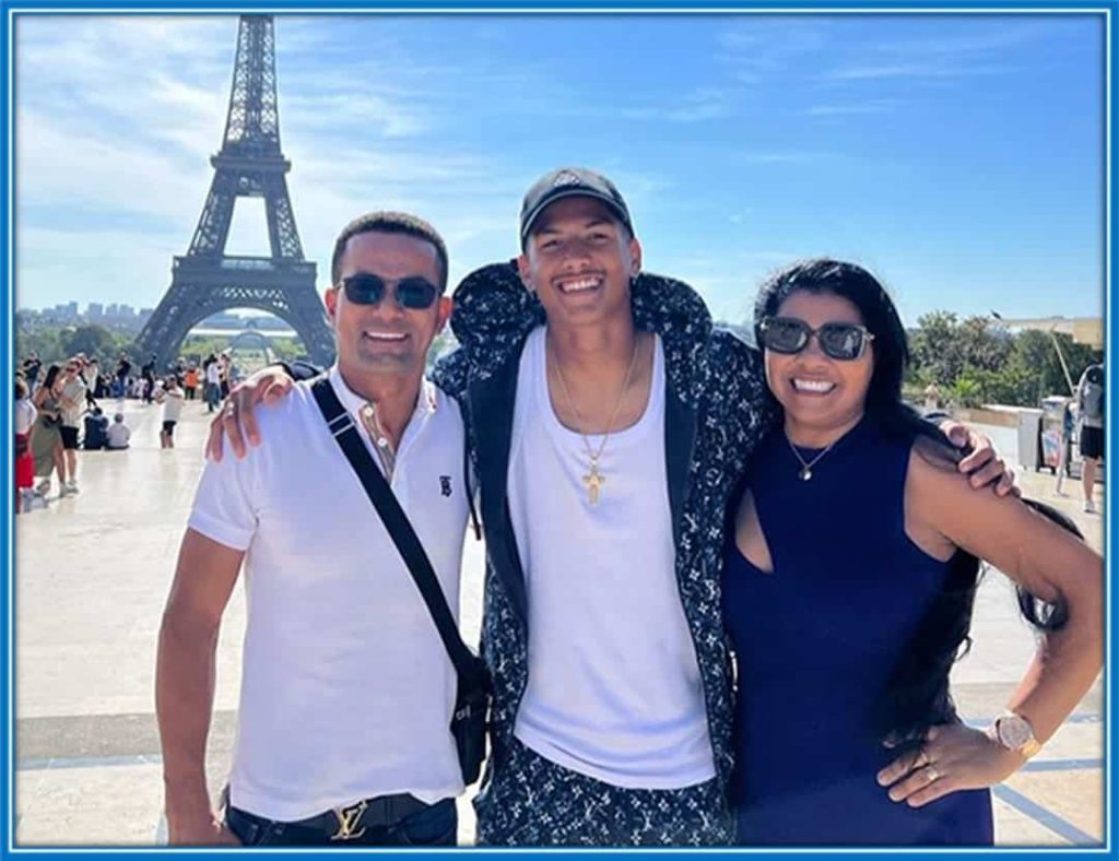 Meet Angelo Gabriel's Parents - his Father, Elismar Damaceno, and Mother, Idene Dias Damasceno. On this day, Angelo decided to set football aside to share a special moment with the foundational figures in his life, visiting the iconic Eiffel Tower.