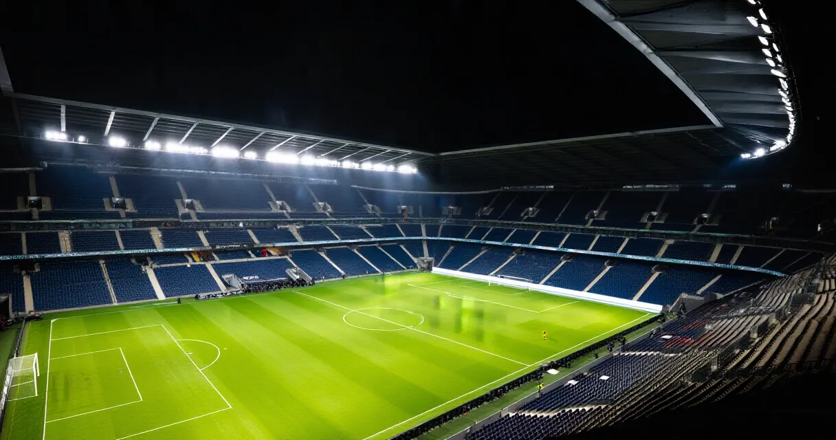 Professional footballer training on pitch in Premier League stadium