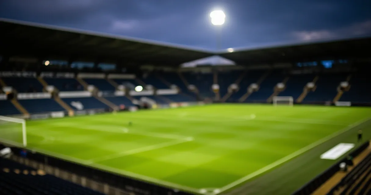 Football manager observing tactics from the touchline at a major stadium