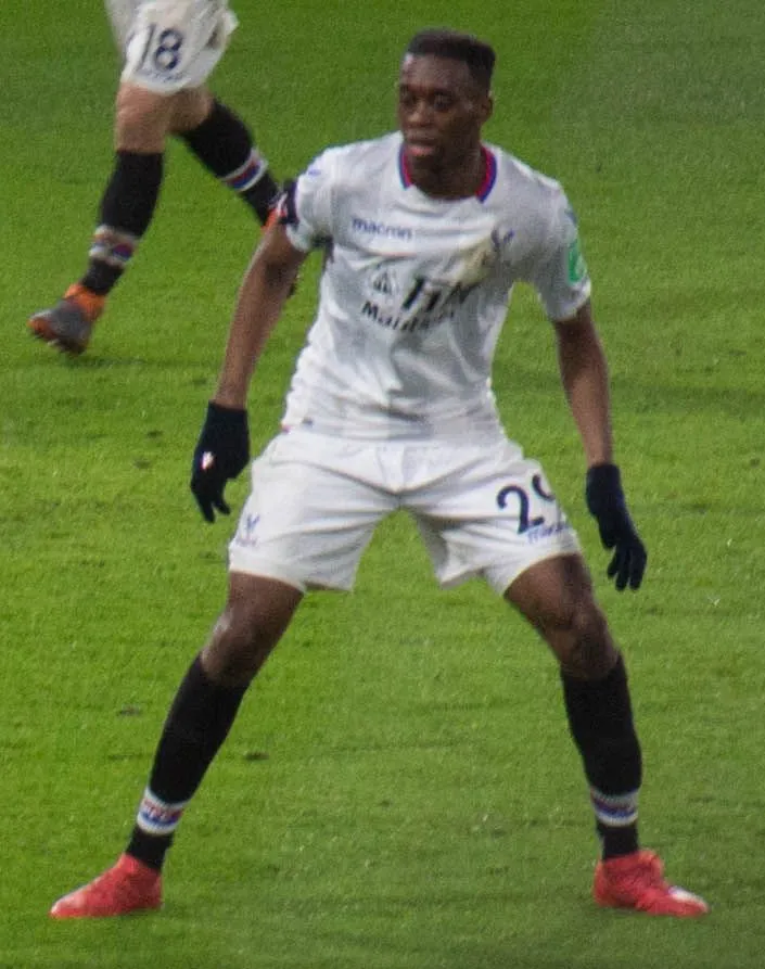 Right-back sprinting down the flank in a Premier League stadium, maroon kit