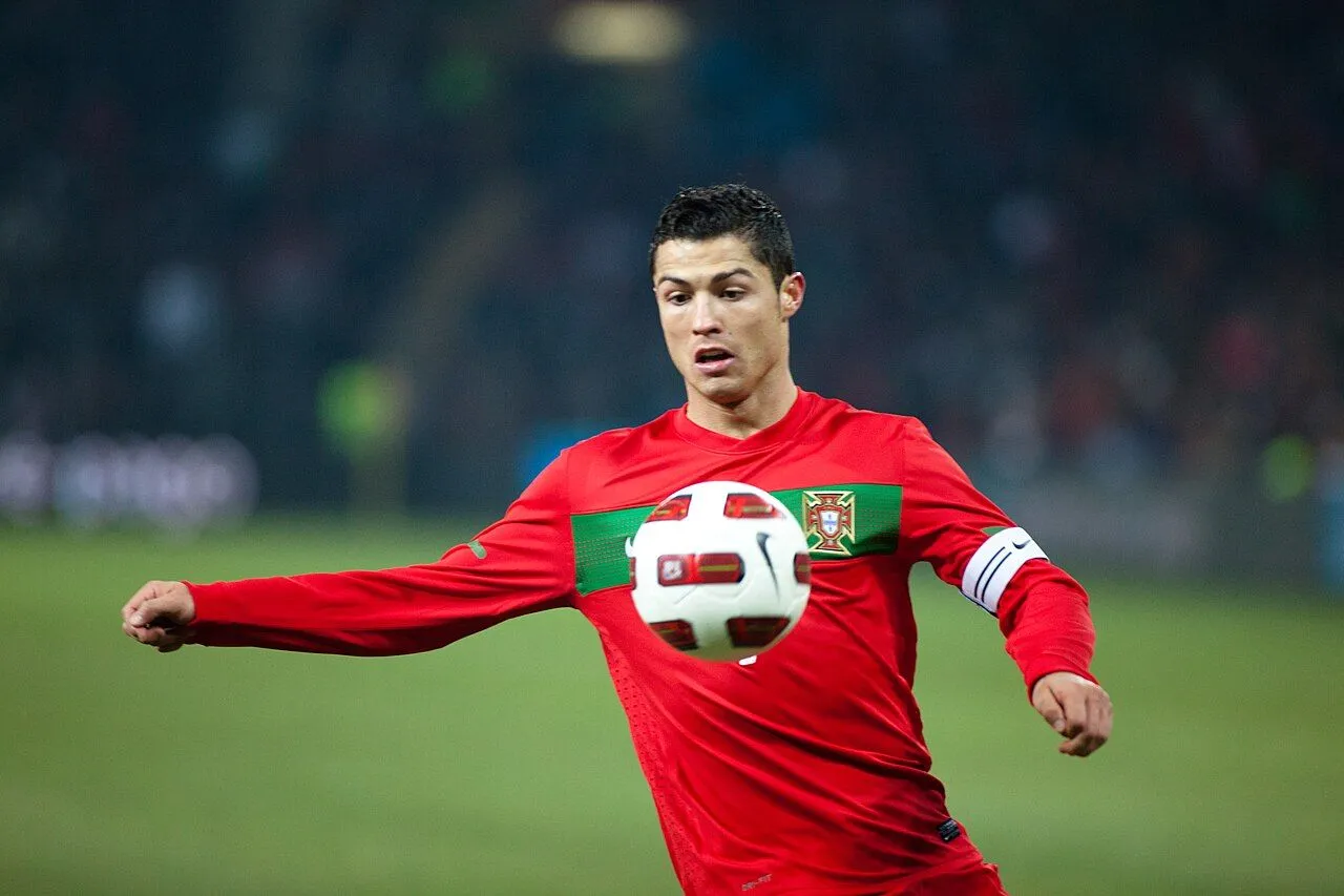Footballer pointing to the sky in emotional gesture during match