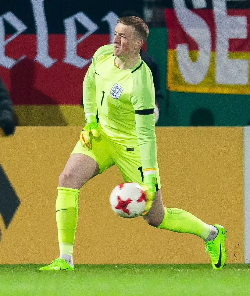 Goalkeeper making a dramatic save during a Premier League match
