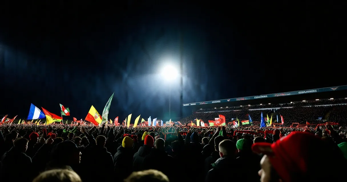 Footballers exchanging jerseys after an international match under stadium floodlights